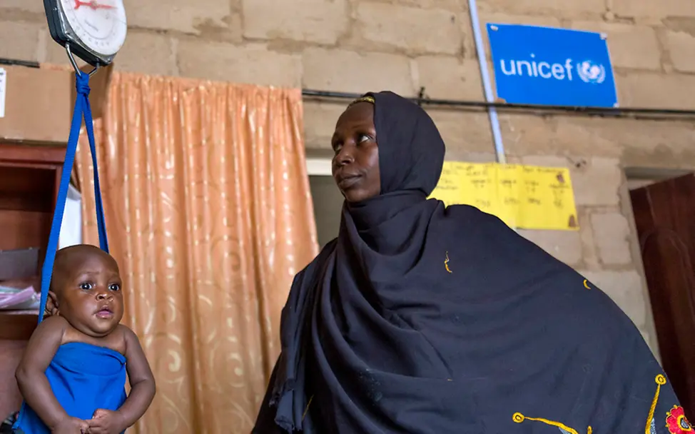 Das Gewicht der kleinen Falmata, sechs Monate alt, gibt Gewissheit über ihren Gesundheitszustand. | © UNICEF/Esiebo Falmata, sechs Monate alt, wird gewogen, um ihren Ernährungsstatus zu bestimmen.
