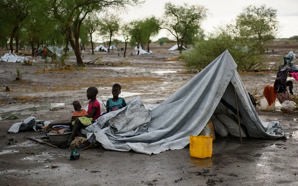 Viele Menschen haben keine Planen und suchen Schutz unter Bäumen | © UNICEF/Hatcher-Moore Südsudan: Mit Beginn der Regenzeit werden Zelte aus Planen errichtet