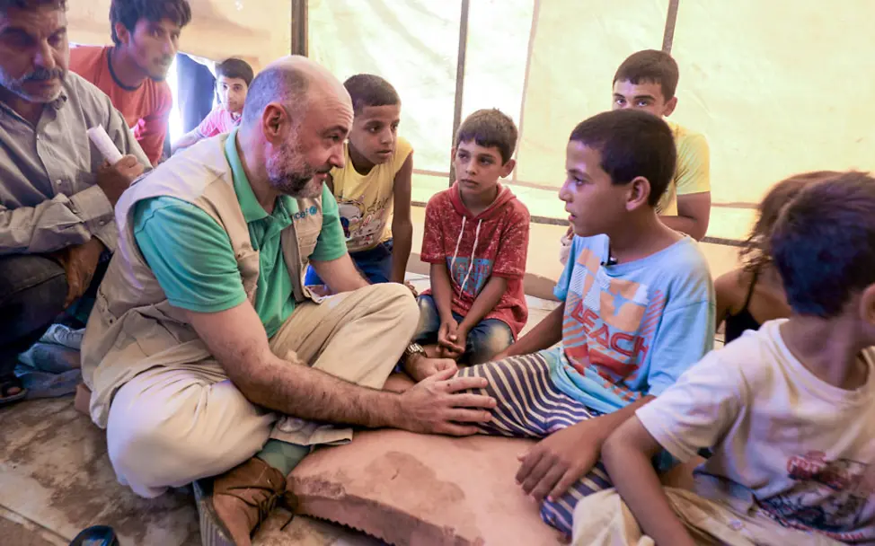 Fran Equiza, Leiter von UNICEF in Syrien, spricht mit Familien | © UNICEF Syria/Delil Souleiman Rakka, Syrien: Fran Equiza, Leiter von UNICEF in Syrien, spricht mit Familien im Flüchtlingscamp