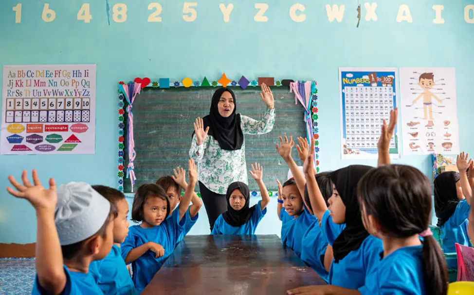 Wer weiß die Antwort? Kinder melden sich in einer Klasse auf den Philippinen © UNICEF/Kokic Philippinen: Kinder im Klassenzimmer