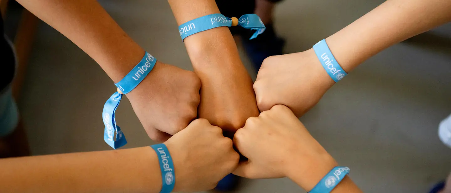 | © UNICEF/UNI825006/Etges Handgelenke mit UNICEF-Armbändern