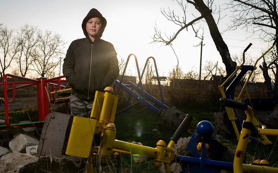Ukraine Teenager: Timofii steht auf einem zerstörten Kindergarten in seinem Heimatdorf