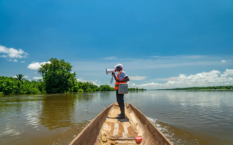 Tansania: Ein Impfhelfer informiert Eltern, dass sie ihre Kinder impfen lassen können.