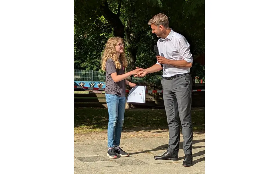 Tiana bei der Überreichung der Teilnahmeurkunde am Kinderbeirat durch Oberbürgermeister Dennis Weilmann | © Stadt Wolfsburg Tiana bei der Überreichung der Teilnahmeurkunde am Kinderbeirat durch Oberbürgermeister Dennis Weilmann.