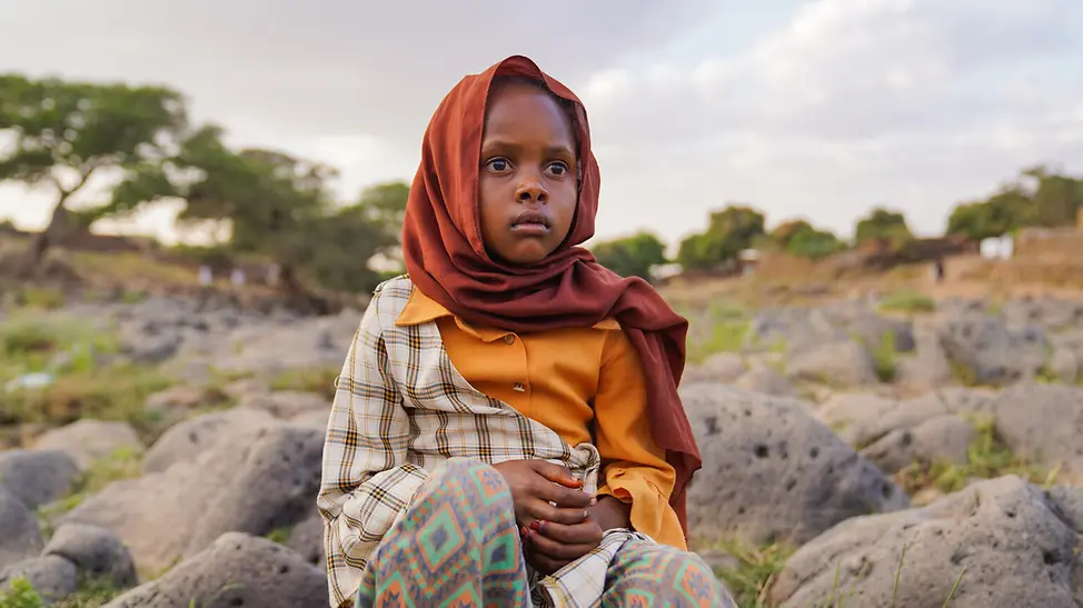 Ein Mädchen im Sudan sitzt auf einem großen Felsblock | © UNICEF/Jamal Sudan Al-Fashir: Die 9-jährige Tuqaa musste vor der Gewalt in ihrer Heimat Al-Fasher fliehen.
