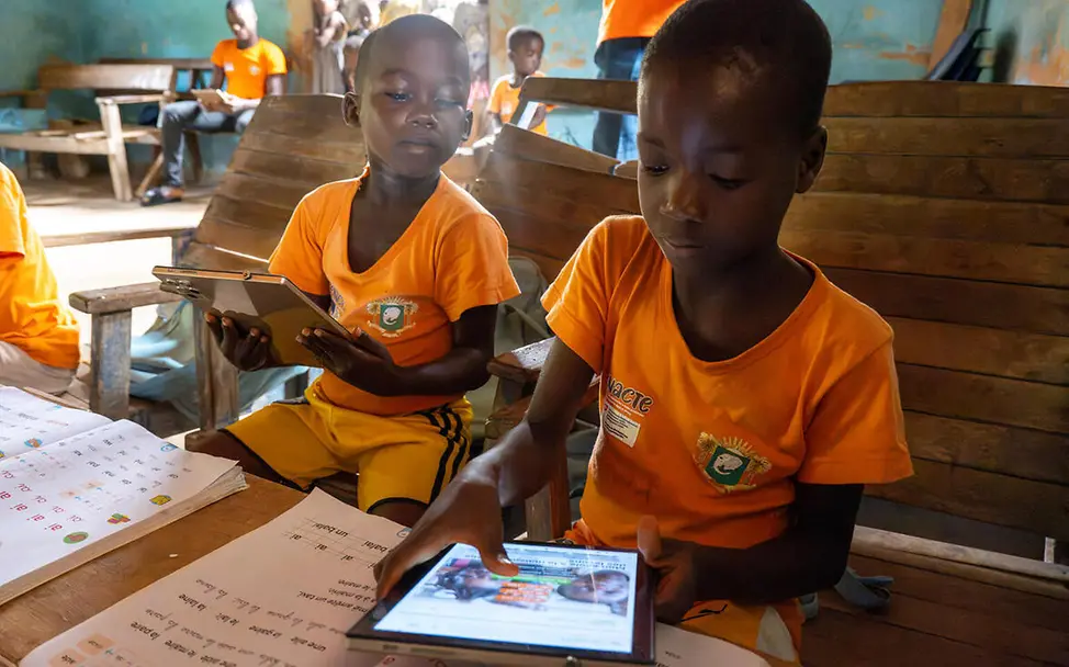 Wenn die nächste Schule für Kinder unerreichbar ist, brauchen sie Alternativen zum Lernen. | © UNICEF/Dejongh SDGs einfach erklärt: Zwei Jungen lernen mit Tablets.