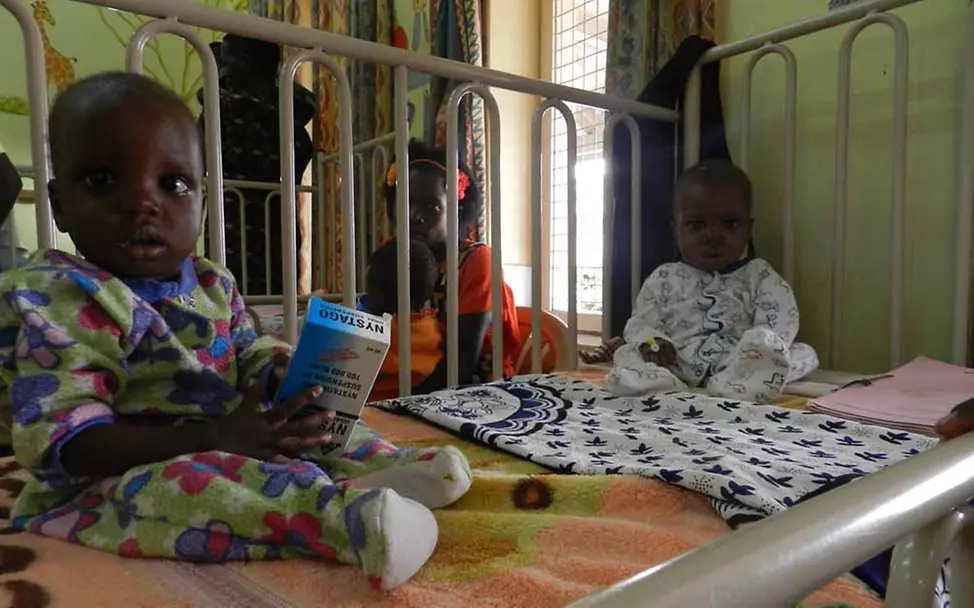 Nicht selten müssen sich zwei Kinder ein Bettchen teilen, wie diese Zwillinge hier auf der Giraffenstation. | © UNICEF/DT2015-23983/Lena Dietz Uganda Babys