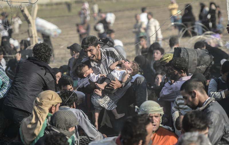 Grenze Syrien/Türkei: Flucht durch den Stacheldraht | © Bülent Kiliç/AFP