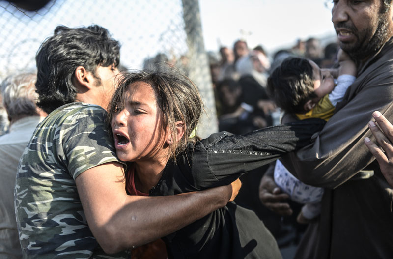 Grenze Syrien/Türkei: Flucht durch den Stacheldraht | © Bülent Kiliç/AFP