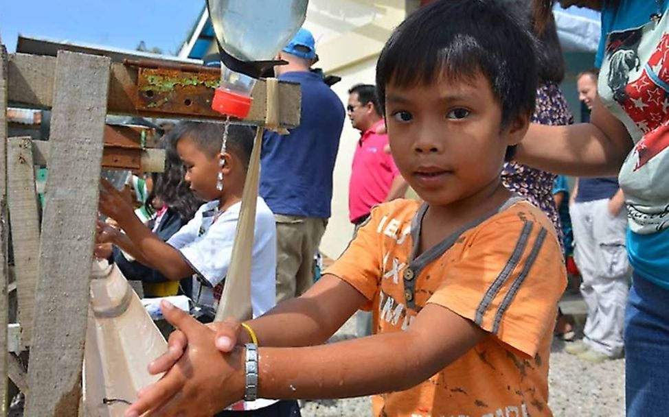 A boy in Tacloban is washing his hands. 