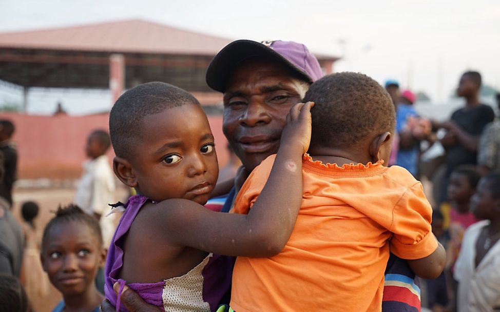 Ein Vater in Nord-Angola ist unendlich froh, seine Kinder wieder in den Armen halten zu können. 