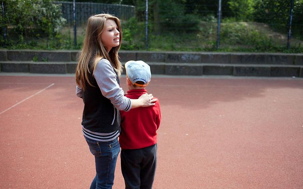 Ein Mädchen und ein Junge auf einem Sportplatz in Berlin (© Liesa Johannssen)