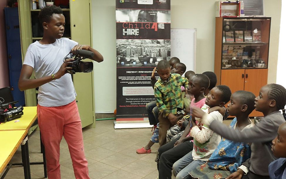 Kenia: Patrick zeigt jüngeren Kindern die Kameraarbeit im Film- und Fotokurs.