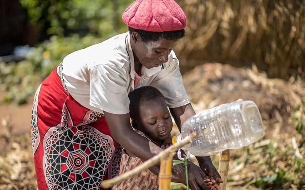Malawi: Esther bringt ihrem Sohn Isaac das Händewaschen bei.