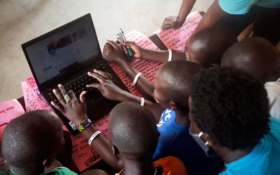 Mädchenbeschneidung in Uganda: Mädchen schauen auf einen Laptop