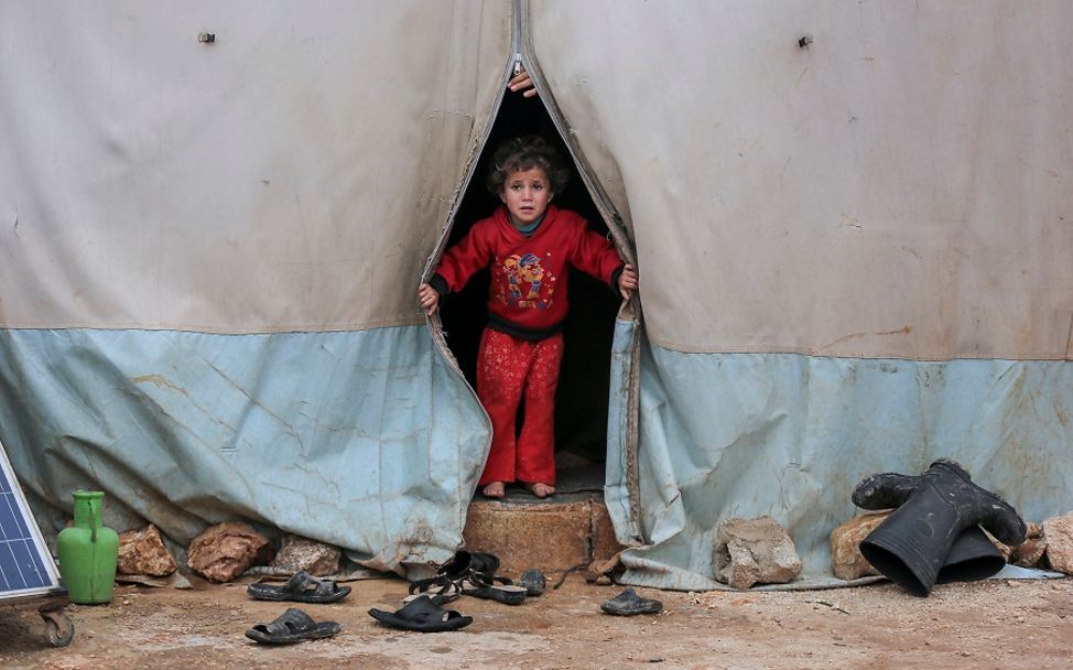 Syrien: Ein Kind schaut aus dem Zelt eines Flüchtlingscamp