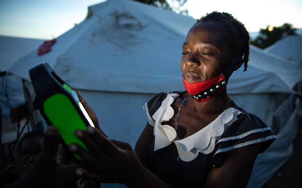 Mosambik Sturm Eloise: Eine Frau hält eine Solarlampe in der Hand