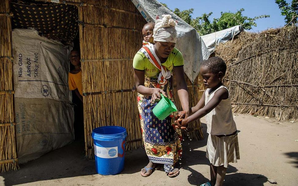 Mosambik: Eine Mutter mit ihren zwei Kindern im Flüchtlingscamp