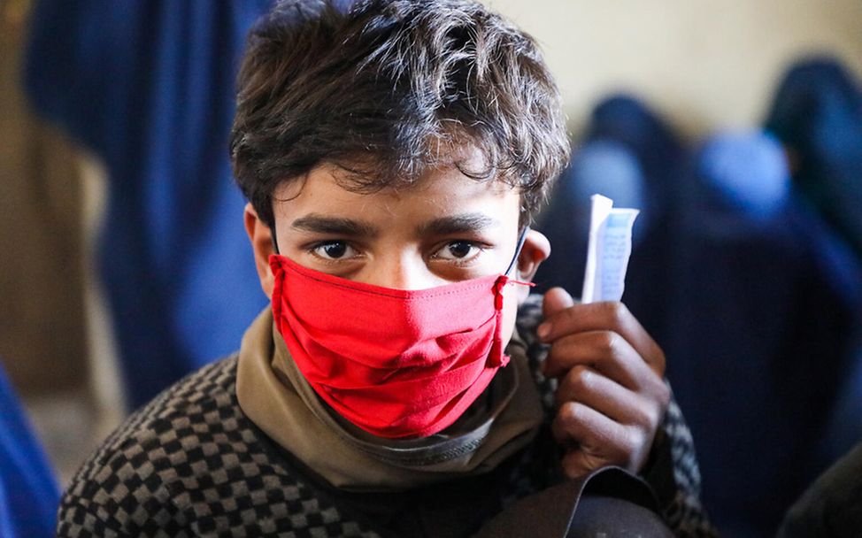 Afghanistan: Ein Junge bei der Bargeld-Ausgabe durch UNICEF