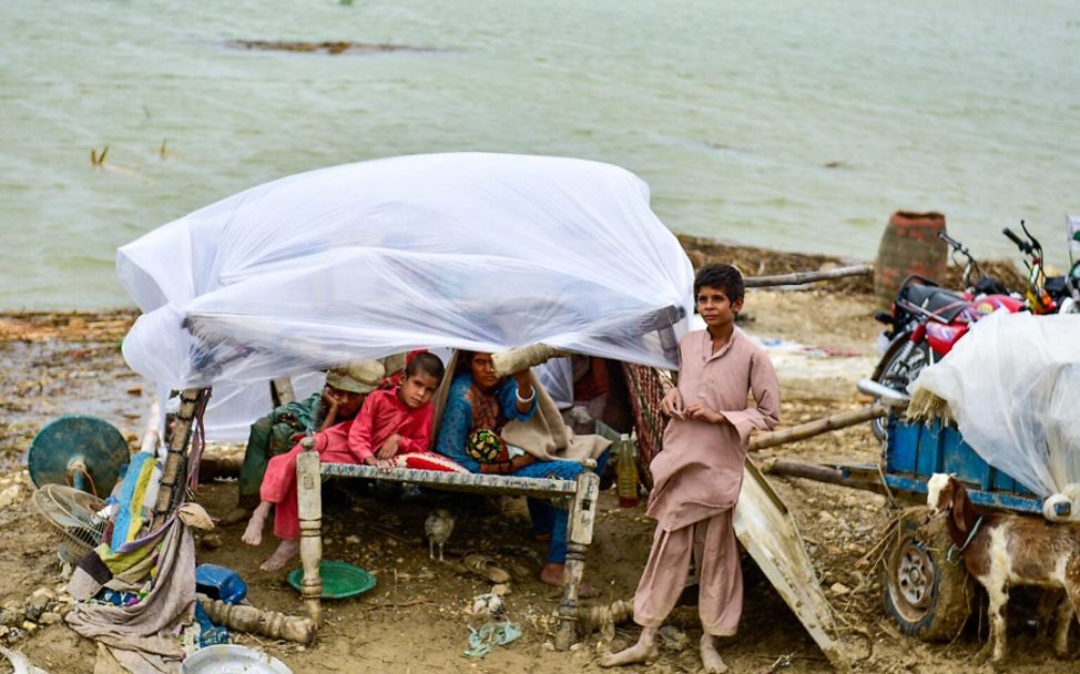 Pakistan Flut: Kinder haben sich aus Treibgut ein Zuhause gebaut.