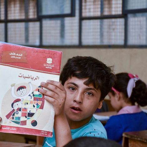 Syrien: Ahmad zeigt hält Schulheft in die Kamera.