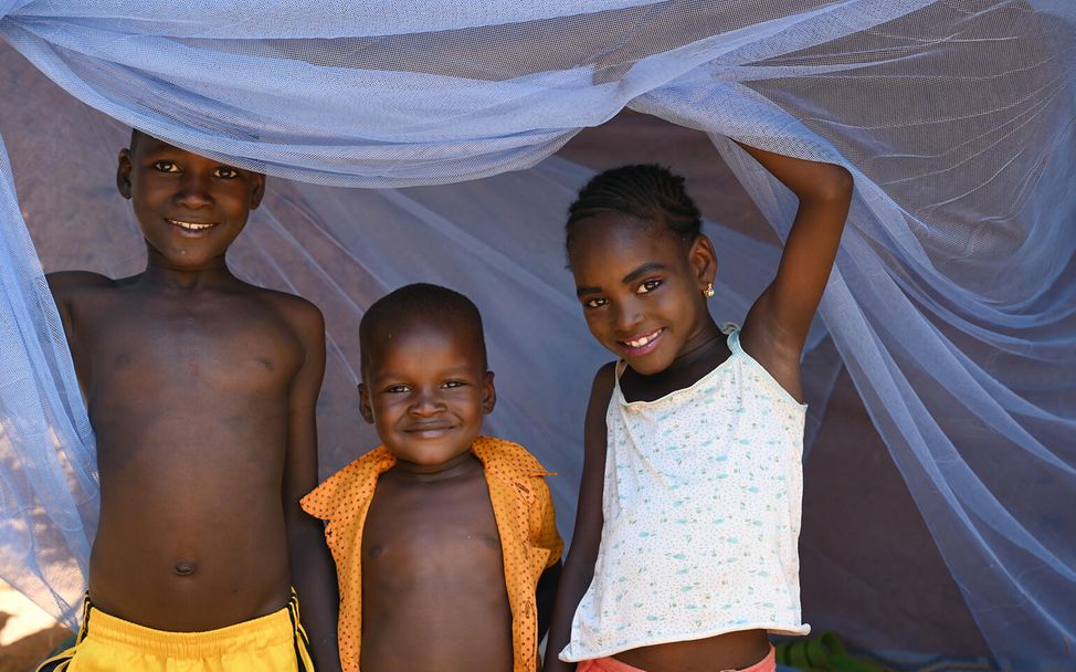 Kinder bereiten sich in Niger auf ihren Schlaf unter einem Moskitonetz vor.