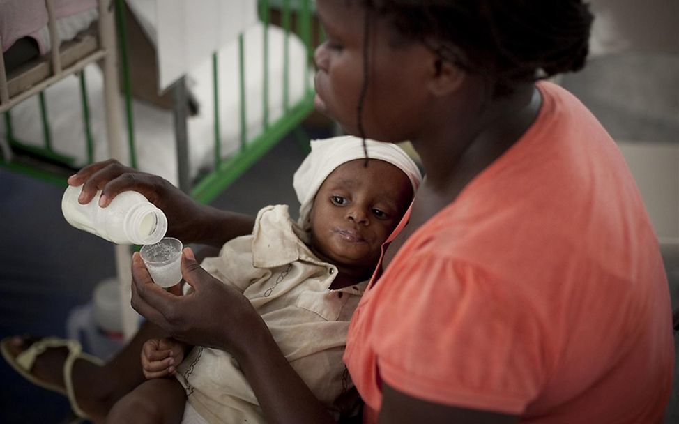 Die Mutter füttert ihr Kind mir strak angereicherten Milch. © UNICEF/Ramoneda