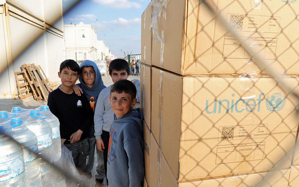 Erdbeben Syrien Türkei: Kinder in der Türkei stehen neben großen UNICEF-Kartons mit Hilfsgütern